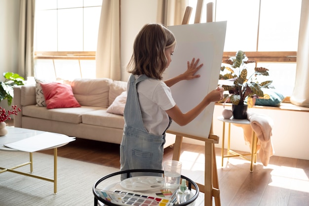 Medium shot girl with canvas