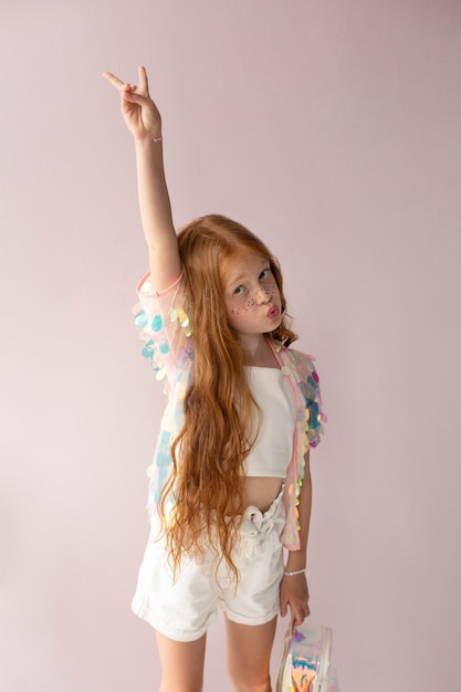 Free photo medium shot girl with ginger hair posing