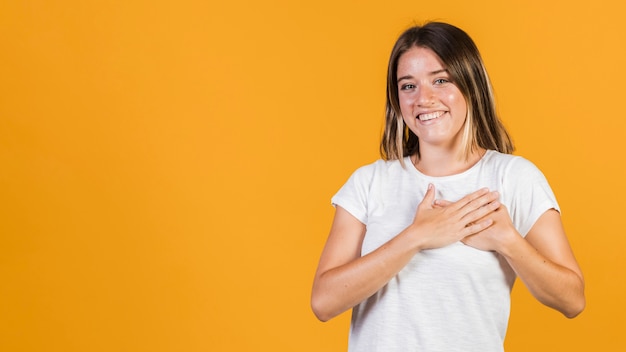 Medium shot girl with hands on her chest