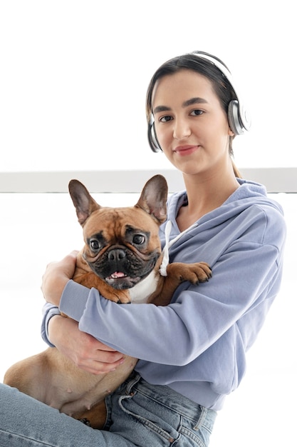 Medium shot girl with headphones and dog