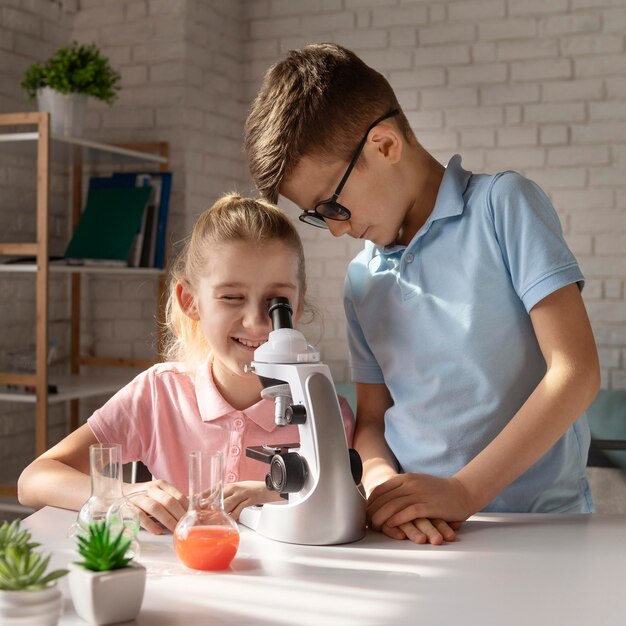 Medium shot girl with microscope