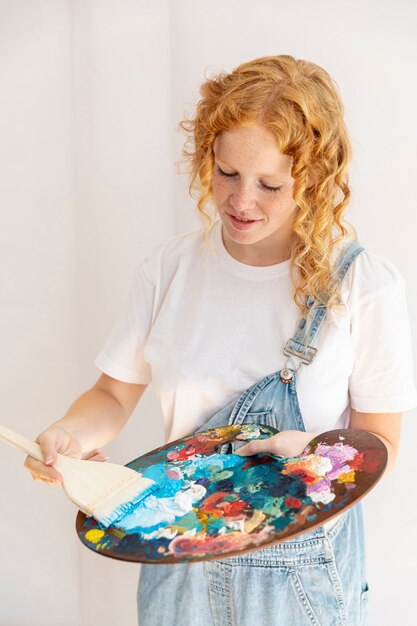 Medium shot girl with painting items