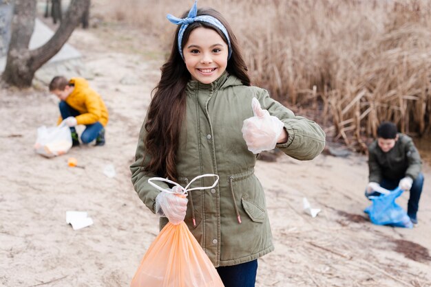 Medium shot of girl with plastic bag