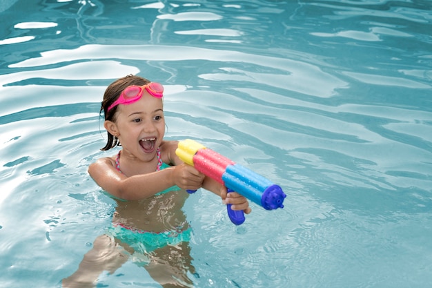 Medium shot girl with water gun