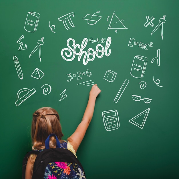 Medium shot girl writing on green board