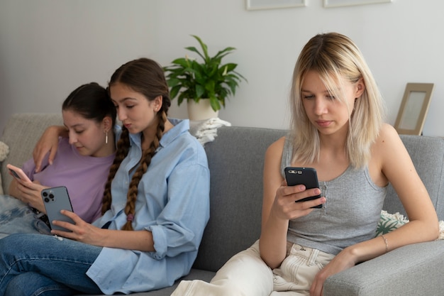 Medium shot girls addicted to smartphones