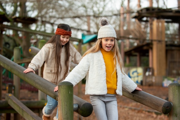 Medium shot girls playing outside