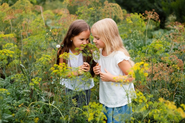 Free photo medium shot girls smelling plant