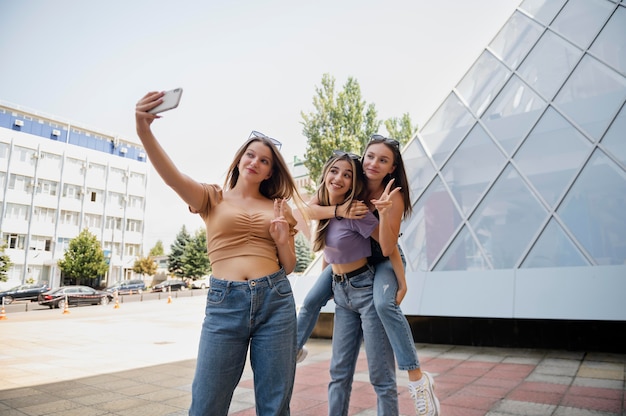 Medium shot girls taking selfie