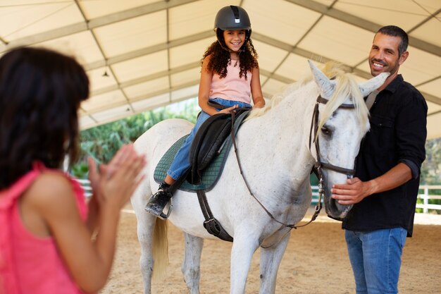 Medium shot girls with beautiful horse