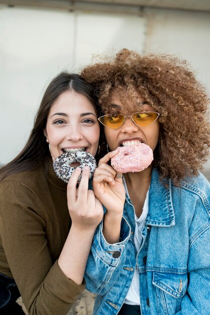 Medium shot girls with doughnuts