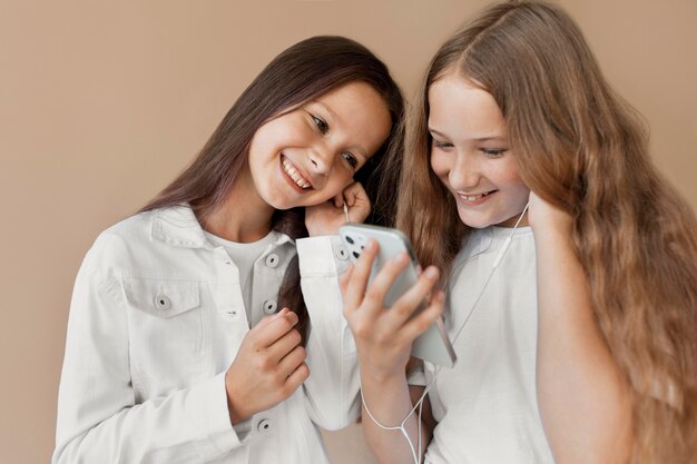 Medium shot girls with smartphone