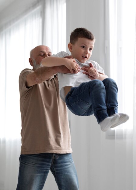 Medium shot grandfather holding boy