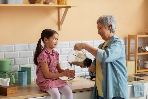 medium-shot-grandma-girl-cooking-togethe