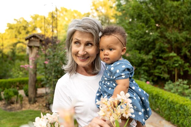 Medium shot grandmother holding baby