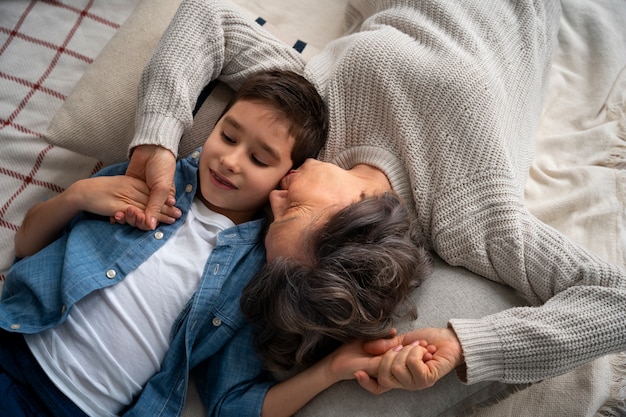 Medium shot grandson and grandmother indoors