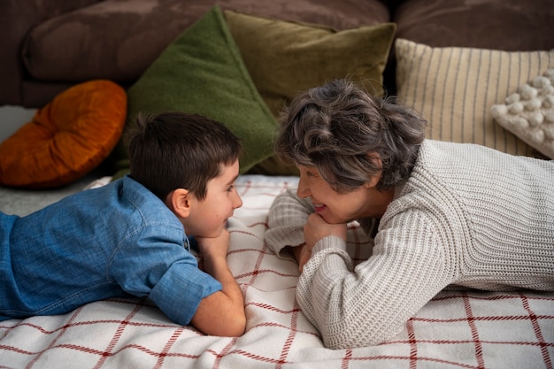 Free photo medium shot grandson and grandmother indoors