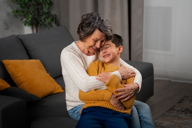 Free photo medium shot grandson and grandmother indoors