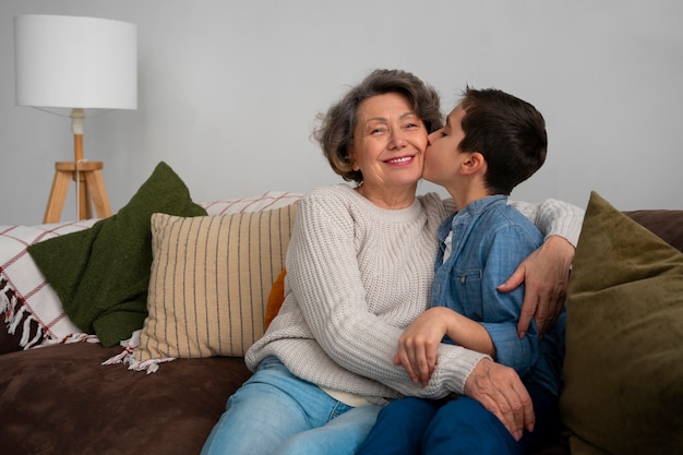 Medium shot grandson kissing grandmother