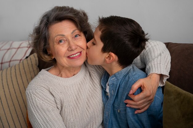 Medium shot grandson kissing grandmother