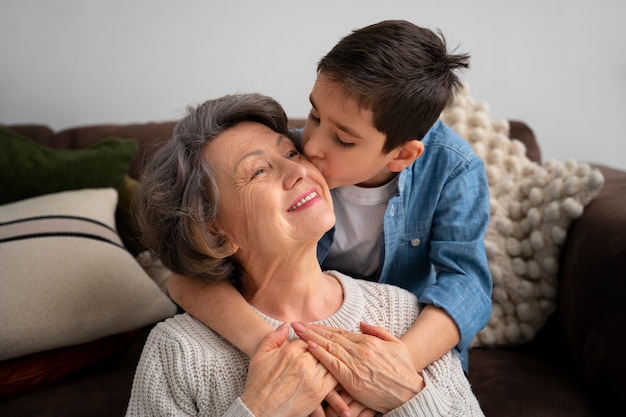 Medium shot grandson kissing grandmother