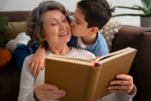 Medium shot grandson kissing grandmother