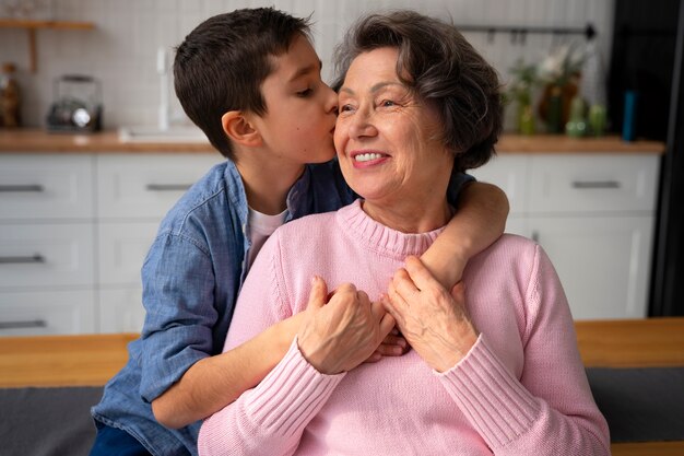 Medium shot grandson kissing grandmother