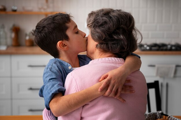 Medium shot grandson kissing grandmother