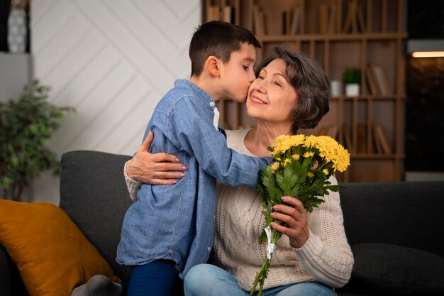 Medium shot grandson kissing grandmother