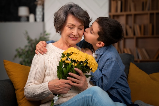 Medium shot grandson kissing grandmother