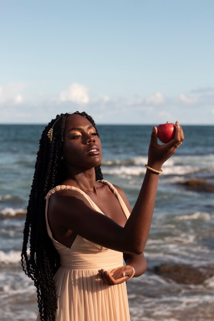 Medium shot greek goddesses posing at the beach