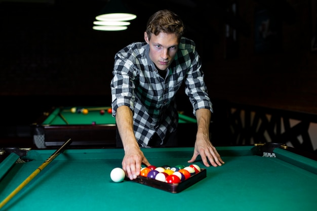 Medium shot guy arranging billiard balls