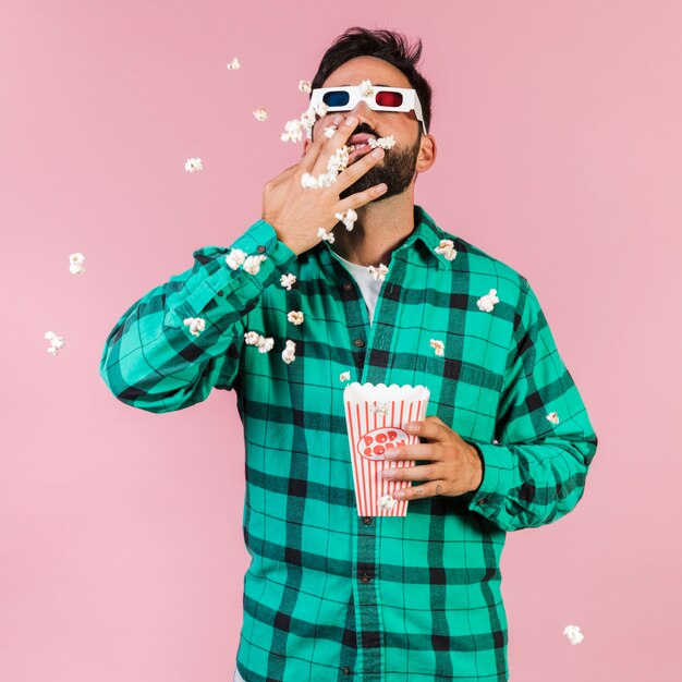 Medium shot guy eating popcorn