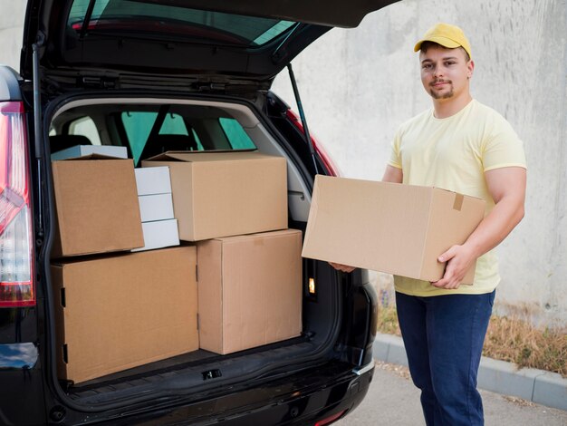 Medium shot guy holding box