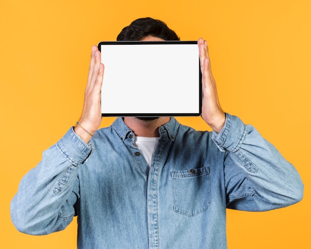 Medium shot guy holding up a tablet