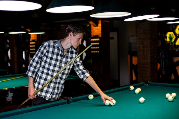 Medium shot guy holding white pool balls 