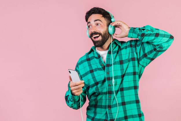 Medium shot guy listening to music 