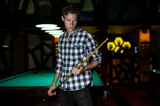 Medium shot guy with pool cue stick