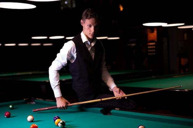 Medium shot guy with vest and pool cue