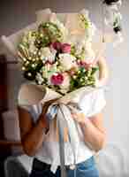 Free photo medium shot hands holding flowers