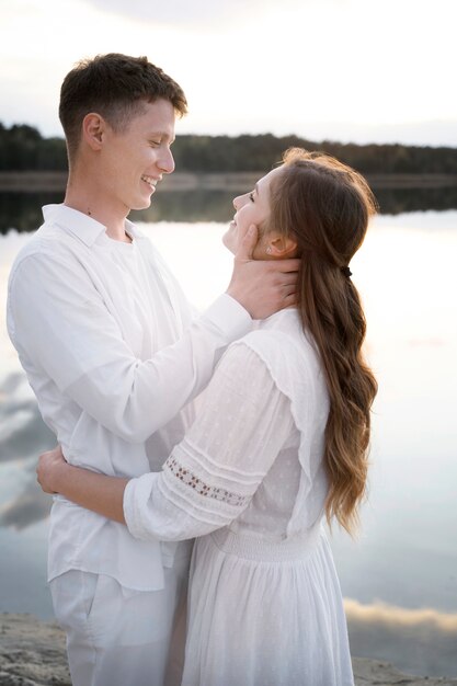 Medium shot happy couple at beach