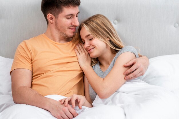 Средний снимок счастливая пара в спальне