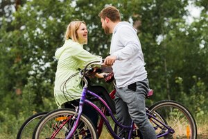 Medium shot of happy couple on bicycles