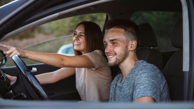 Medium shot happy couple in car