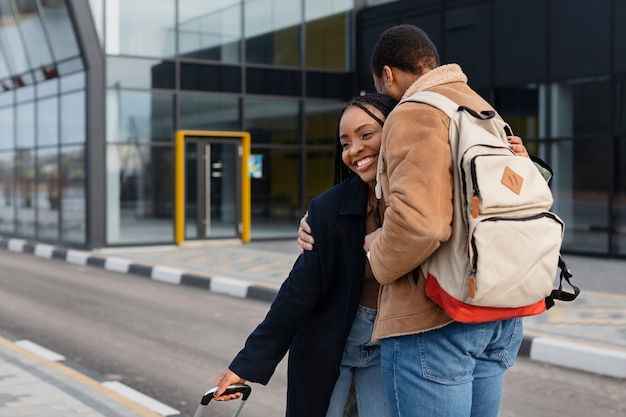 Medium shot happy couple meeting outdoors