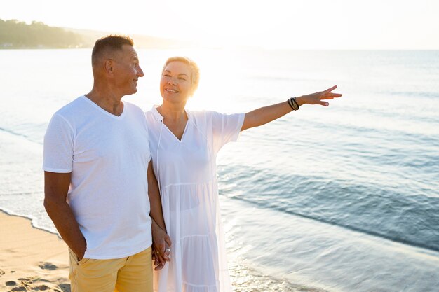 Medium shot happy couple at seaside