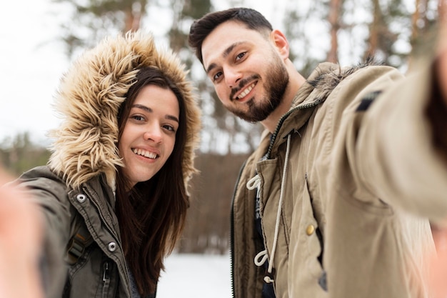 Medium shot happy couple taking selfie