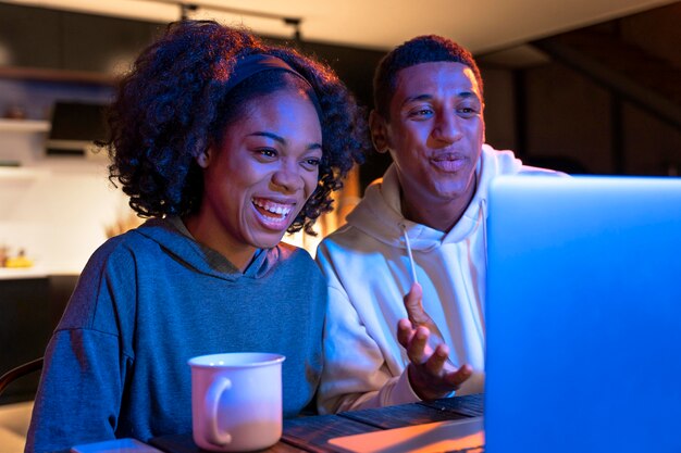 Medium shot happy couple with laptop