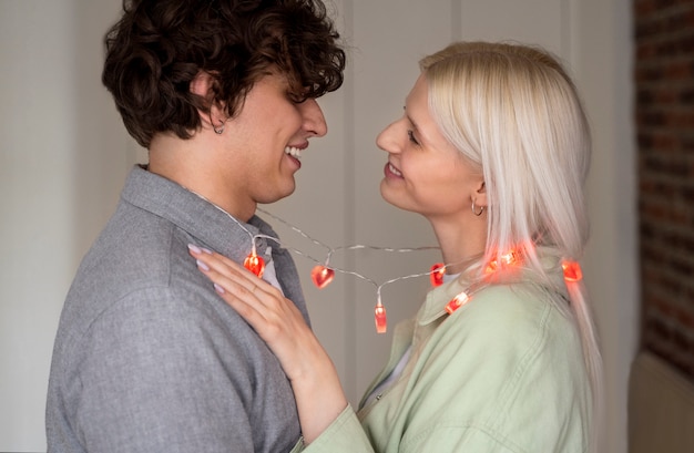 Free photo medium shot happy couple with lights