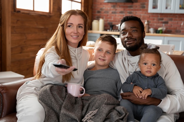 Medium shot happy family on couch